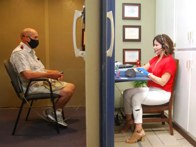 heather conducting a hearing test