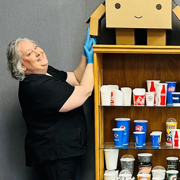 misty smiling and stocking a shelf