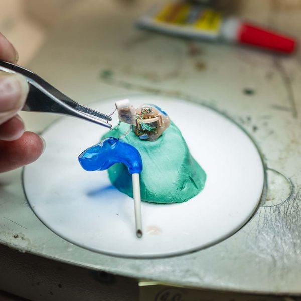 a hearing aid being repaired