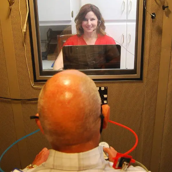 heather testing a patient for hearing loss